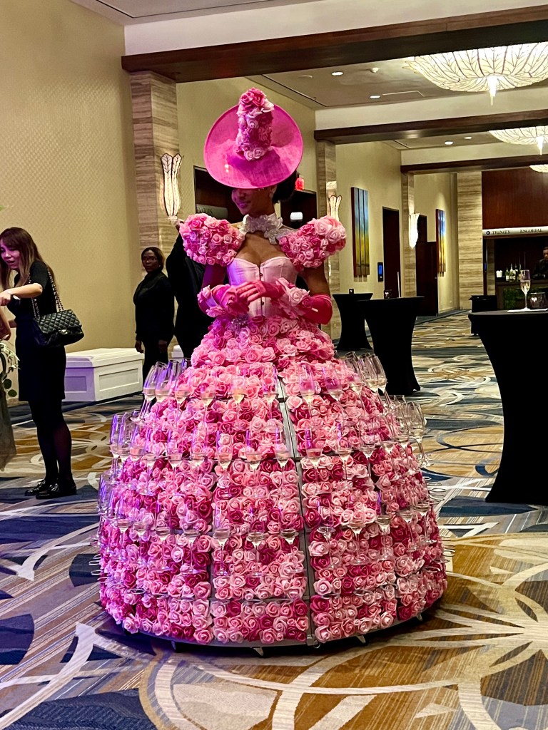 Book a Strolling Champagne Diva to serve your guests champagne from her glamorous ball gown