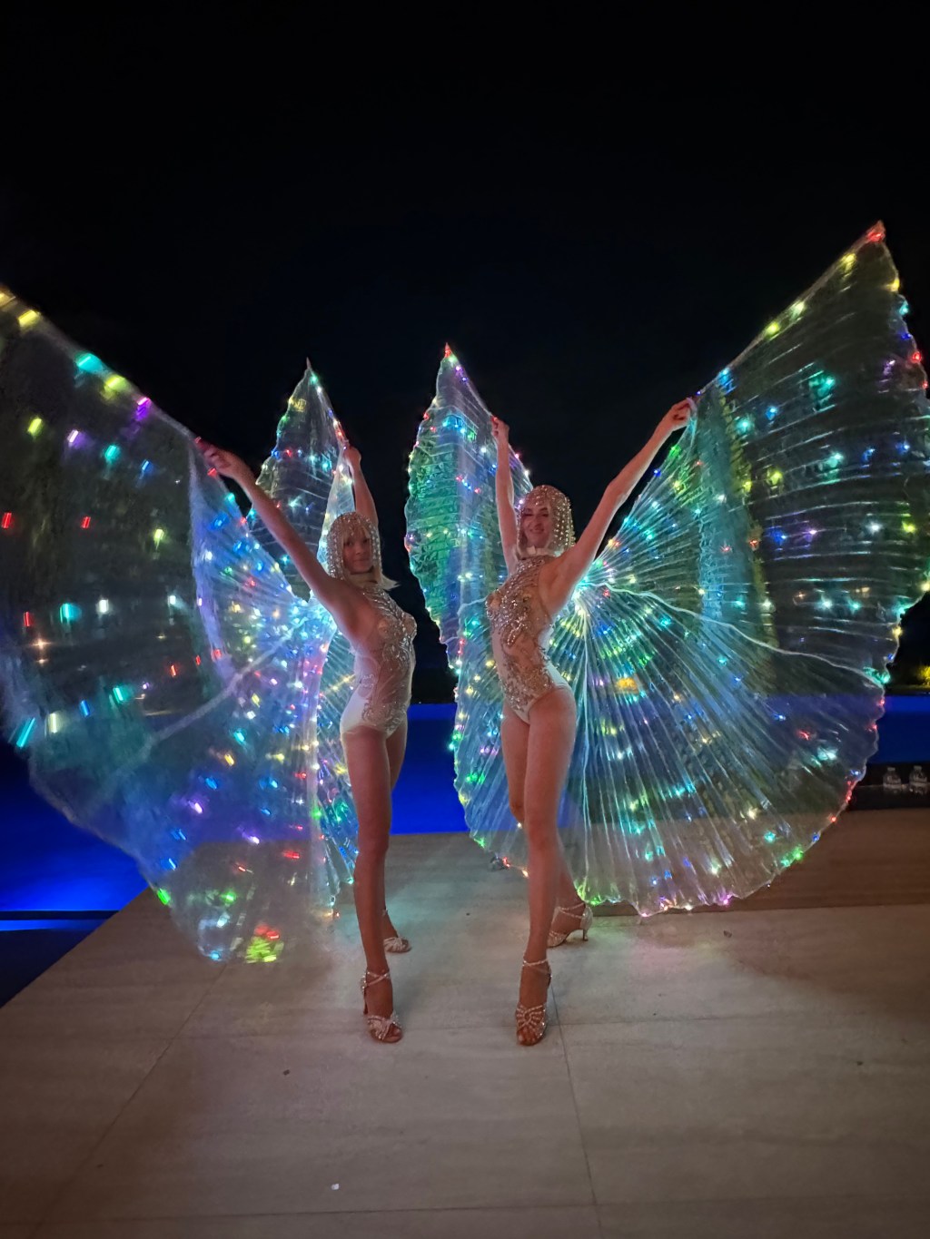 High-energy LED dancers with glowing costumes performing at a live event